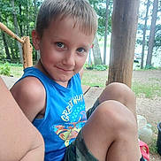Takoda joined the competition — help win amazing prizes! child, boy, smiling, portrait, outdoors, forest, woodland, picnic, bench, blue_shirt, camouflage_shorts, blond_hair, sitting, knees, nature, trees, daylight, candid, happy, family