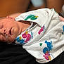 newborn, baby, sleeping, blanket, duck_pattern, nasal_tube, infant, wrapped, peaceful, closeup, person, child, bedroom, soft_focus, human, cute, healthcare, resting, swaddled, treatment