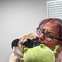 Sparkie joined the competition — help win amazing prizes! woman, dog, pug, puppy, glasses, plush_toy, green_toy, indoor, window_blinds, holding, face, pet, cute, affection, person, love, close_up, casual, home, smile