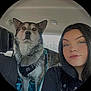 dog, woman, car_interior, seat, harness, pet, portrait, black_hair, animal, face, head, seatbelt, leisure, travel, companion, furry, domestic_animal, young_adult, casual, indoors