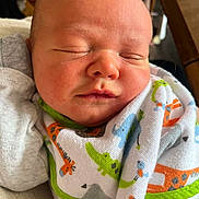 Emmett joined the competition — help win amazing prizes! baby, newborn, sleeping, blanket, infant, face, closeup, peaceful, soft_light, cute, child, wrapped, animal_print, skin, portrait, indoor, resting, small, cozy, toddler