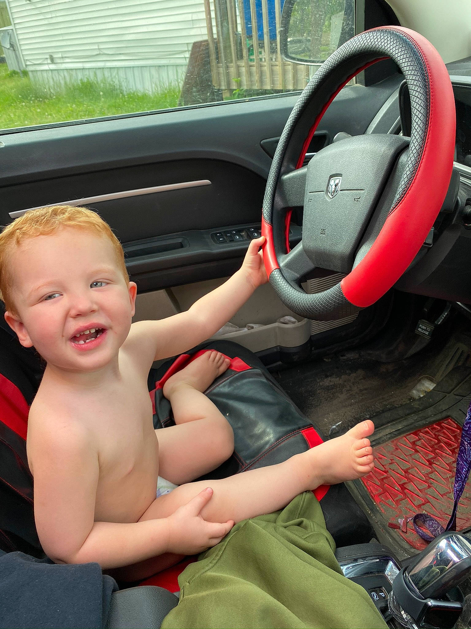 Thorin is registered to the contest to win money with this photo: auto_part, automotive_design, automotive_exterior, car, car_seat, car_seat_cover, family_car, luxury_vehicle, motor_vehicle, person, personal_luxury_car, smile, speedometer, steering_part, steering_wheel, thigh, thumb, toddler, vehicle, vehicle_door