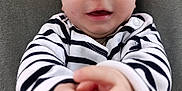 Ernest a rejoint le concours — aidez-le/la à gagner de superbes lots ! baby, infant, child, face, hands, striped_clothing, black_and_white, smile, expression, curious, closeup, portrait, cute, soft_background, indoor, person, skin, head, eyes, young