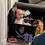Mylan participe au concours pour gagner de l'argent avec cette photo : baby, child, indoor, toy, storage_bin, pirate_symbol, foam_puzzle, couch, floor, basket, play, curious, seated, room, home, pillow, smile, young_child, colorful, furniture