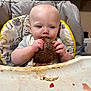 Jasper is registered to the contest to win money with this photo: baby, high_chair, chocolate, cake, messy, food, child, eating, face, hands, bib, indoor, table, tray, smudge, mess, person, young_child, cute, feeding