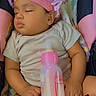baby, sleeping, infant, child, portrait, pink_bonnet, hat, bottle, baby_bottle, blanket, cushion, seated, indoors, close_up, peaceful, nap, pink, clothing, sticker, princess