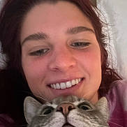Balto joined the competition — help win amazing prizes! person, cat, face, smile, closeup, pet, animal, feline, portrait, indoor, happy, young_adult, eyes, whiskers, nose, hair, relaxed, casual, human, friendship