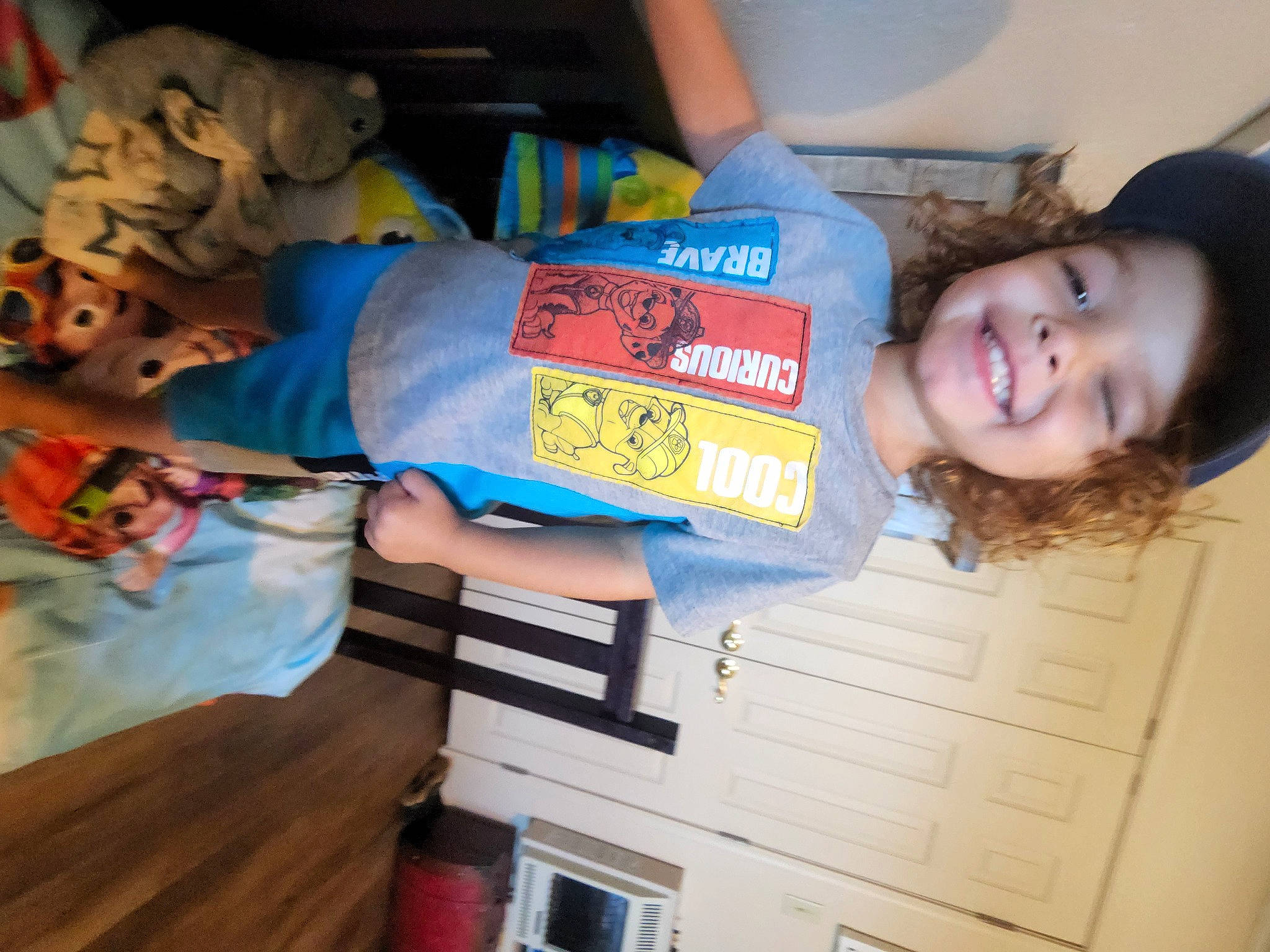 Easton is registered to the contest to win money with this photo: baby_toddler_clothing, child, electric_blue, family_car, fun, happy, joy, person, room, smile, t_shirt, thumb, toddler, wood