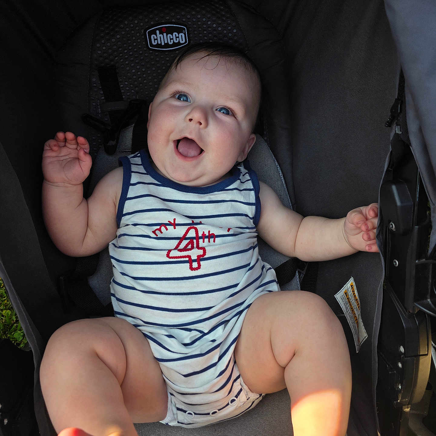 Hudson joined the competition — help win amazing prizes! baby, child, smiling, blue_eyes, striped_clothing, onesie, stroller, happy, infant, barefoot, outdoor, cute, chubby, sitting, playful, face, arms, legs, light, portrait