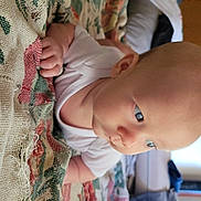 Spencer joined the competition — help win amazing prizes! baby, infant, child, onesie, blanket, patterned_blanket, indoor, blue_eyes, skin, head, face, hand, lying_down, curious, soft_light, cozy, person, toddler, closeup, portrait