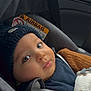 baby, child, car_seat, knit_hat, sweater, toy, seatbelt, indoors, portrait, face, blue_eyes, cute, warm_clothing, infant, car_interior, closeup, soft_light, seat, baby_boy, cozy