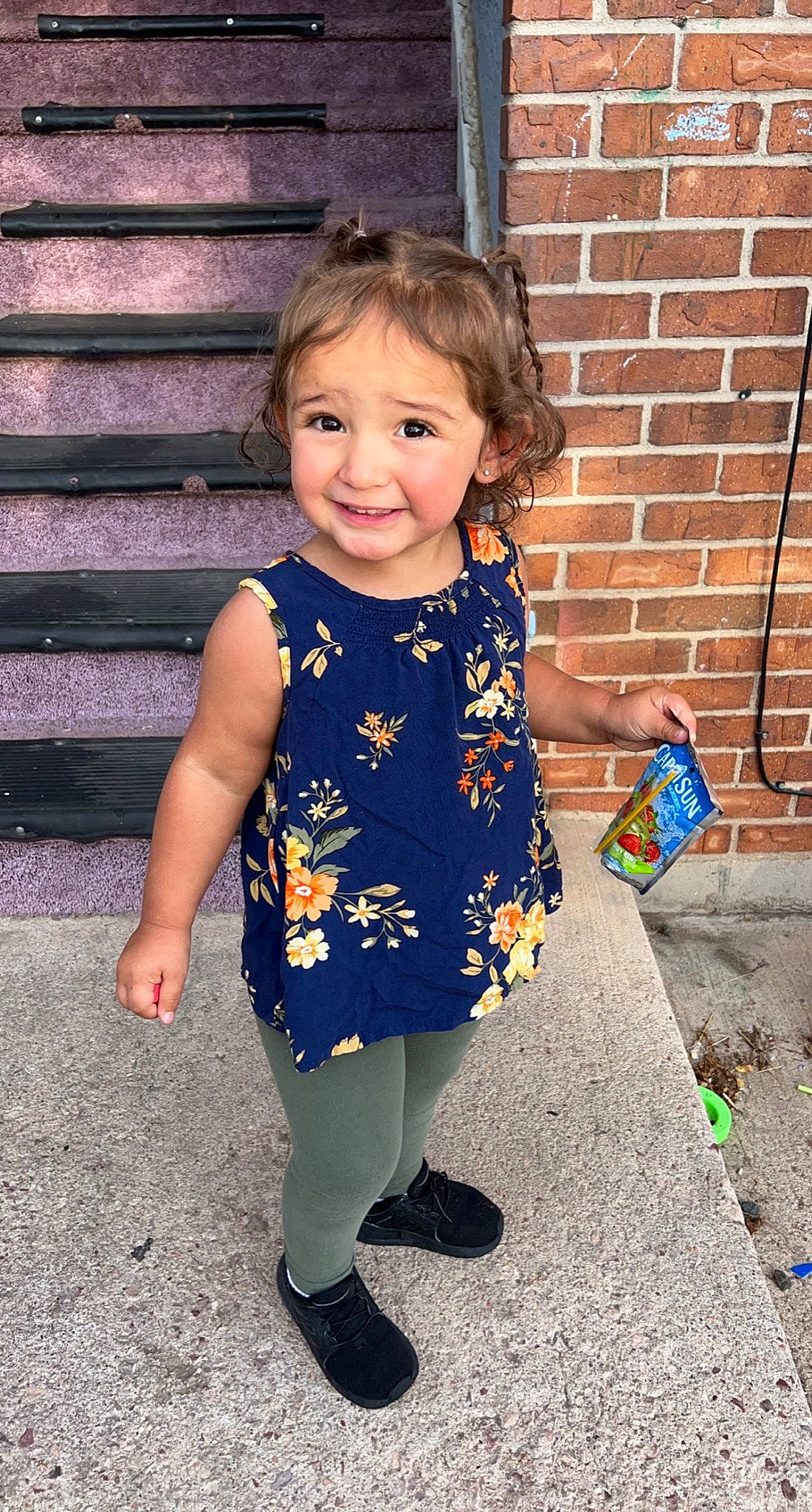 Jaylynn joined the competition — help win amazing prizes! baby_toddler_clothing, brick, brickwork, child, dress, electric_blue, eye, face, hair, hairstyle, happy, head, human_body, joy, leg, people_in_nature, person, sleeve, smile, standing