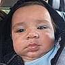 Levi is registered to the contest to win money with this photo: baby, infant, child, face, portrait, close_up, serious_expression, car, car_seat, vehicle_interior, hood, blue_shirt, jacket, sitting, indoors, head, eyes, cheeks, selfie, photography