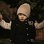 autumn, beanie, bokeh, child, cute, eyes, face, hands, hat, holding_hand, hoodie, jacket, number_82, outdoor, pants, park, portrait, serious_expression, toddler, varsity_jacket