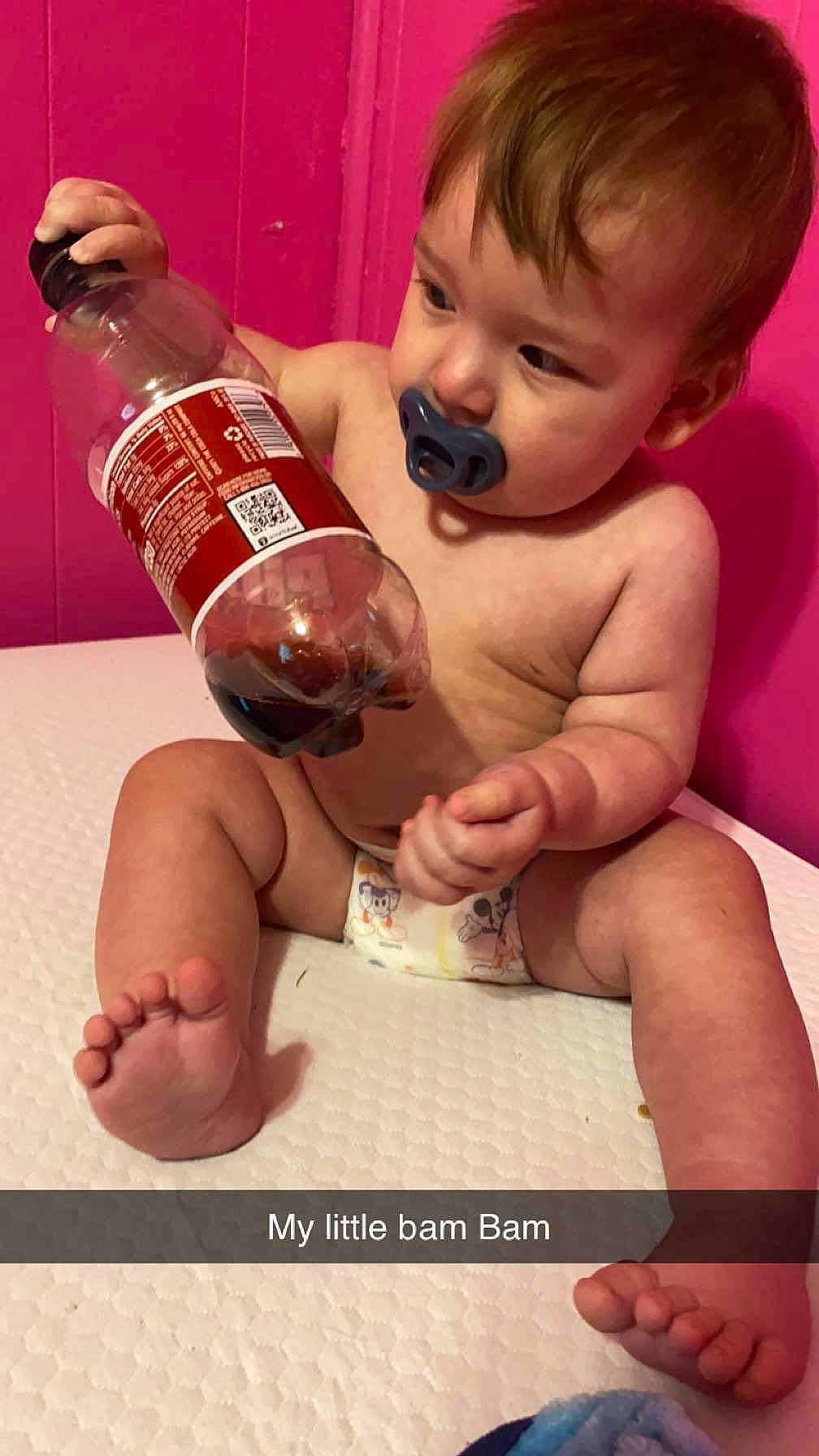 Dean Dempsey is registered to the contest to win money with this photo: baby, bottle, chest, child, drink, drinkware, eyelash, finger, fluid, gesture, hand, leg, muscle, nail, person, plastic_bottle, skin, thigh, thumb, toddler