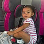 Namirah joined the competition — help win amazing prizes! toddler, child, car_seat, pink, grey, striped_onesie, sneakers, baby, seatbelt, car_interior, portrait, sitting, cute, young_child, clothing, footwear, looking_away, indoors, serious_expression, blanket