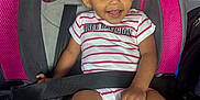 Namirah is registered to the contest to win money with this photo: toddler, child, car_seat, smiling, happy, striped_onesie, hair_clip, seat_belt, pink, gray, sitting, baby, infant, cute, portrait, indoor, car_interior, person, clothing, safety