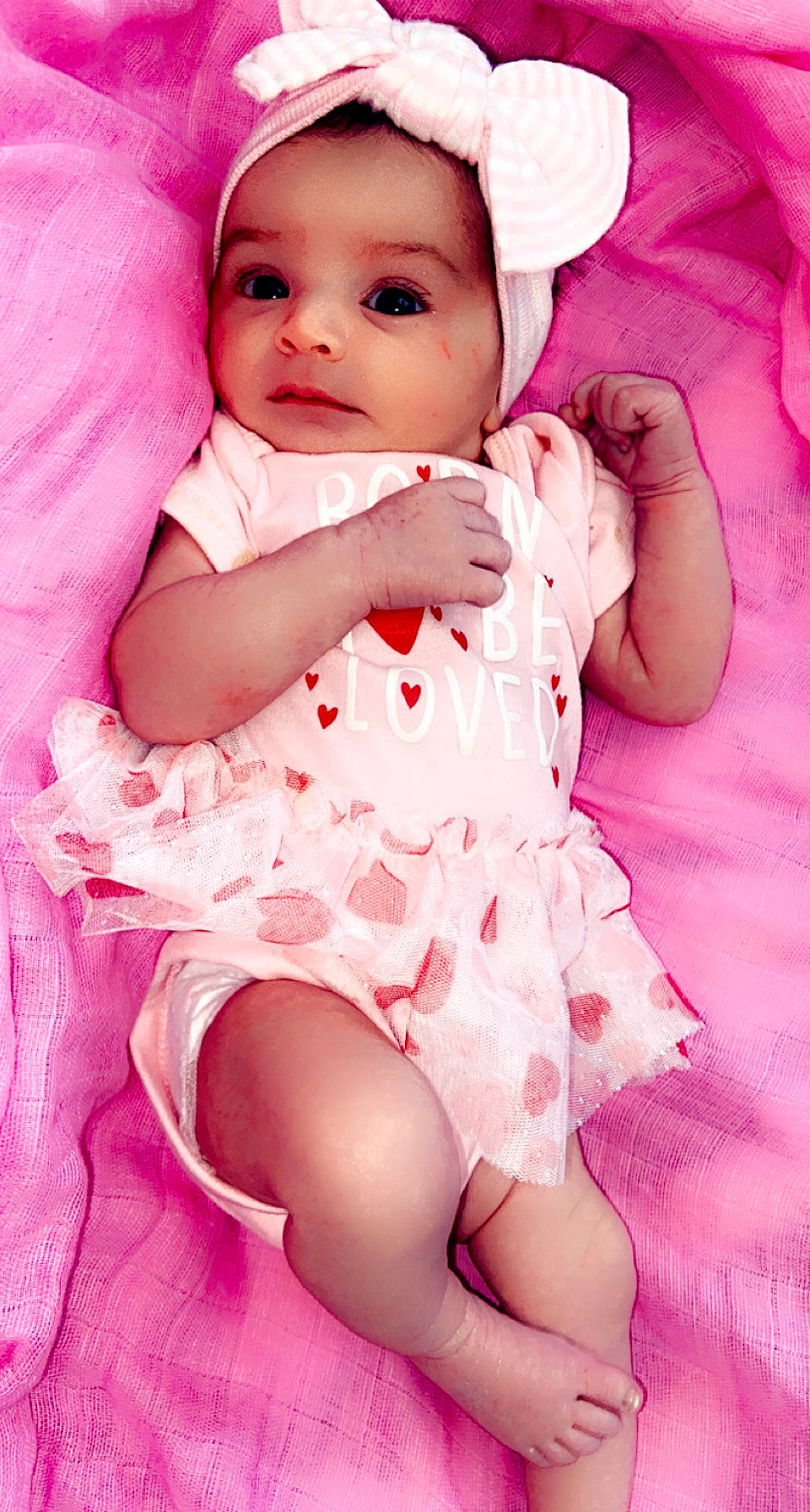 Londyyn is registered to the contest to win money with this photo: baby, baby_toddler_clothing, cap, cheek, child, collar, human_leg, iris, lip, magenta, pattern, person, pink, purple, sitting, skin, sleeve, textile, thigh, toddler