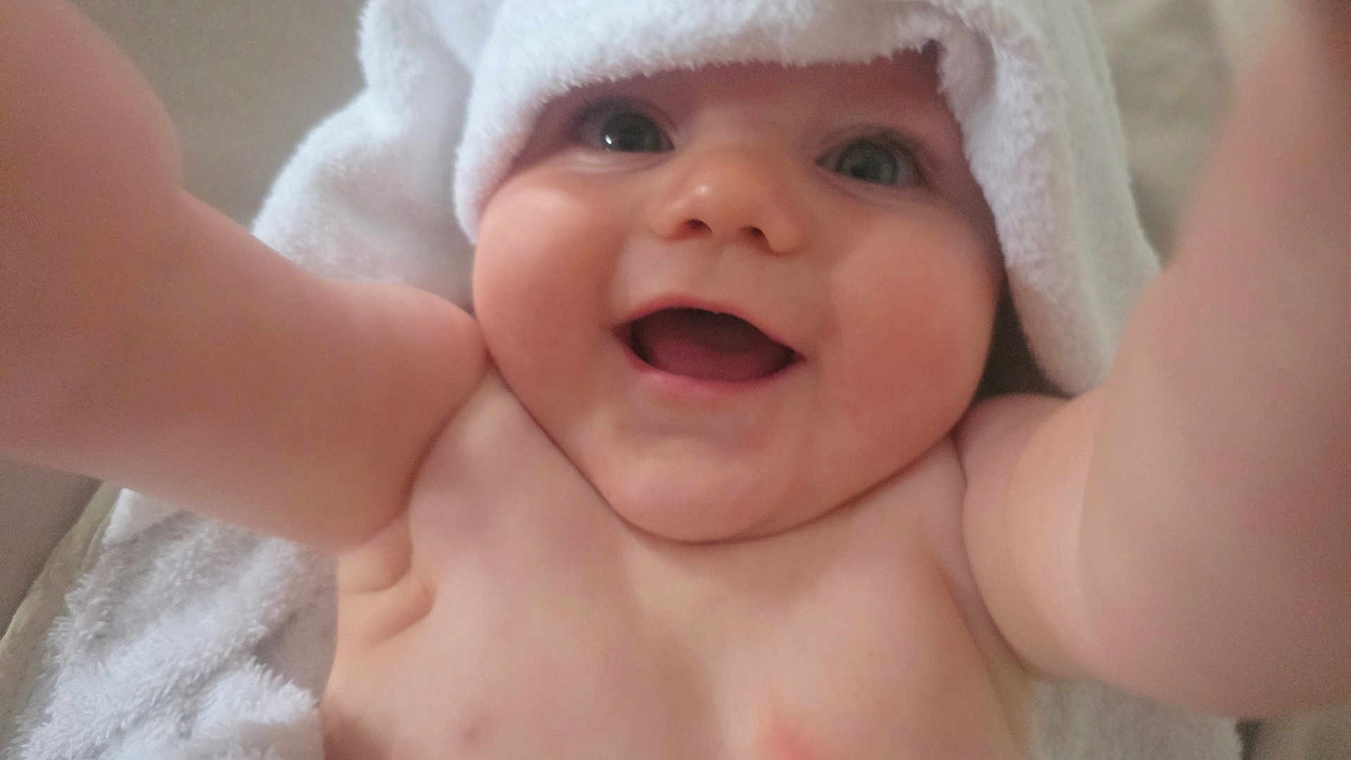 Leo-John is registered to the contest to win money with this photo: baby, smile, towel, bare_chest, happy, child, cute, infant, arms, skin, portrait, closeup, cheeks, headwear, person, young, joy, expression, indoors, face