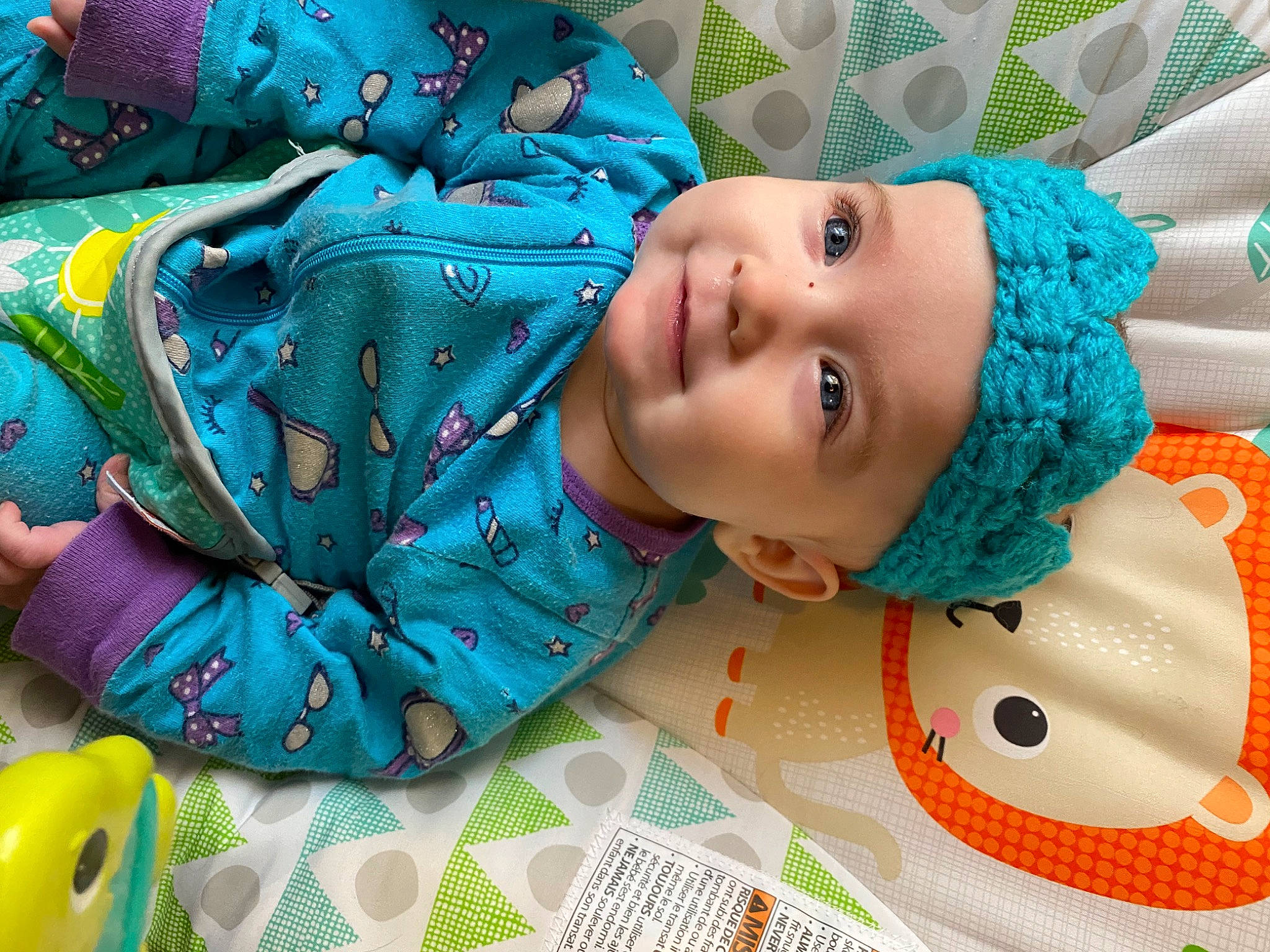 Eleanor joined the competition — help win amazing prizes! aqua, azure, baby, baby_products, baby_toddler_clothing, blue, child, electric_blue, event, fashion_accessory, green, happy, hat, headwear, linens, pattern, person, room, smile, textile