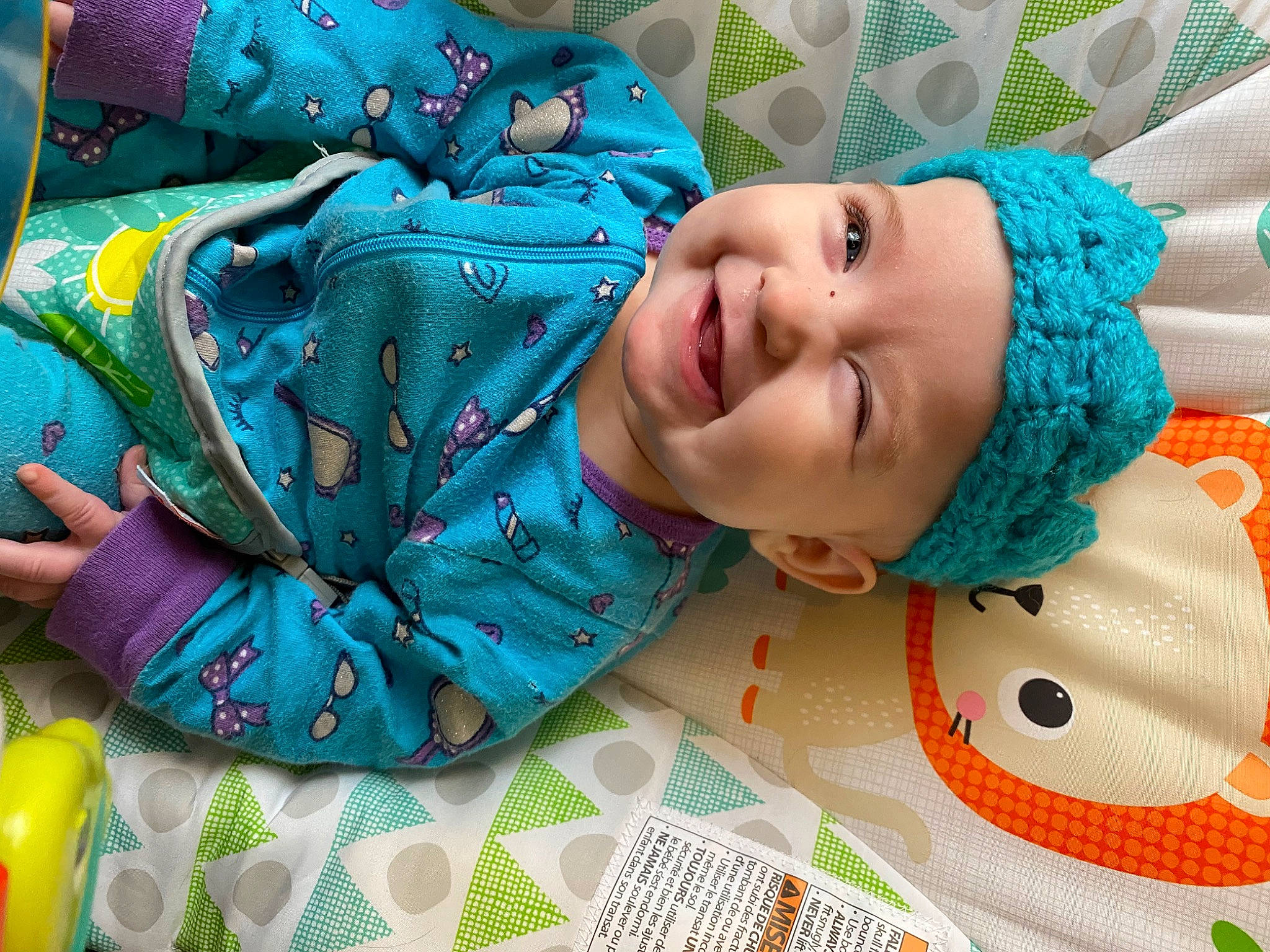 Eleanor is registered to the contest to win money with this photo: aqua, azure, baby, baby_laughing, baby_toddler_clothing, child, comfort, electric_blue, event, fashion_accessory, green, happy, headwear, linens, pattern, person, room, sleeve, smile, textile
