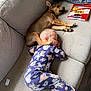 child, toddler, dog, sleeping, couch, pajamas, paw, snack, doritos, pet, indoor, relaxation, nap, cozy, comfort, rest, furniture, animal, home, cute