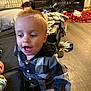 Jaxon joined the competition — help win amazing prizes! toddler, child, indoor, plaid_shirt, happy, person, floor, couch, blanket, furniture, wooden_floor, clothing, face, mouth_open, head, hair, baby, casual, home, expression