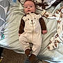 Atlas is registered to the contest to win money with this photo: baby, onesie, bed, blanket, bottle, carpet, clothing, face, footwear, furniture, infant, person, plush, portrait, sleepwear, smile, toy_pattern, foot, jeans, indoor