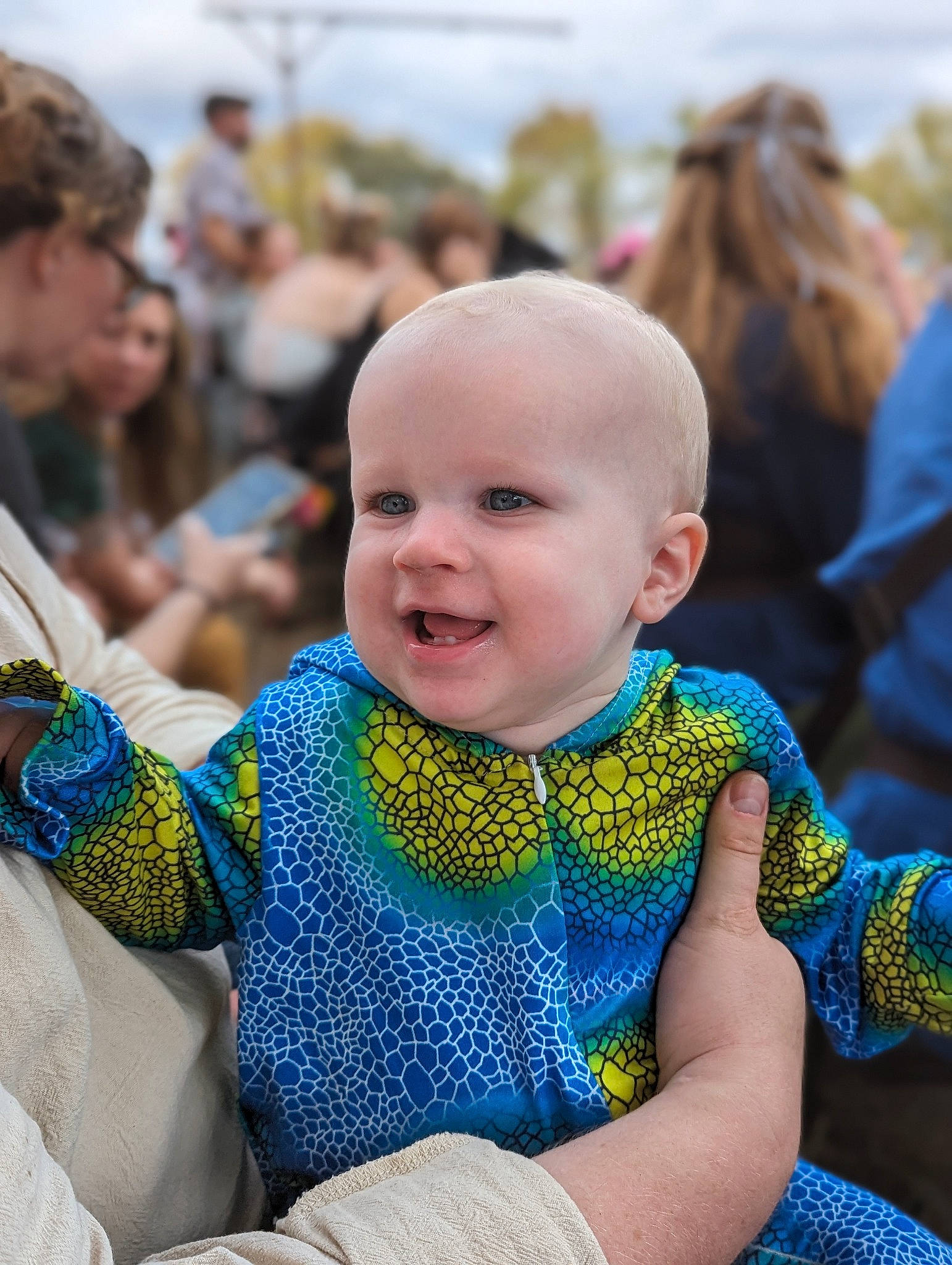 Alex is registered to the contest to win money with this photo: baby, baby_toddler_clothing, blurred, child, crowd, electric_blue, event, eye, fun, grass, happy, iris, jewellery, joy, leisure, pattern, person, recreation, sitting, skin