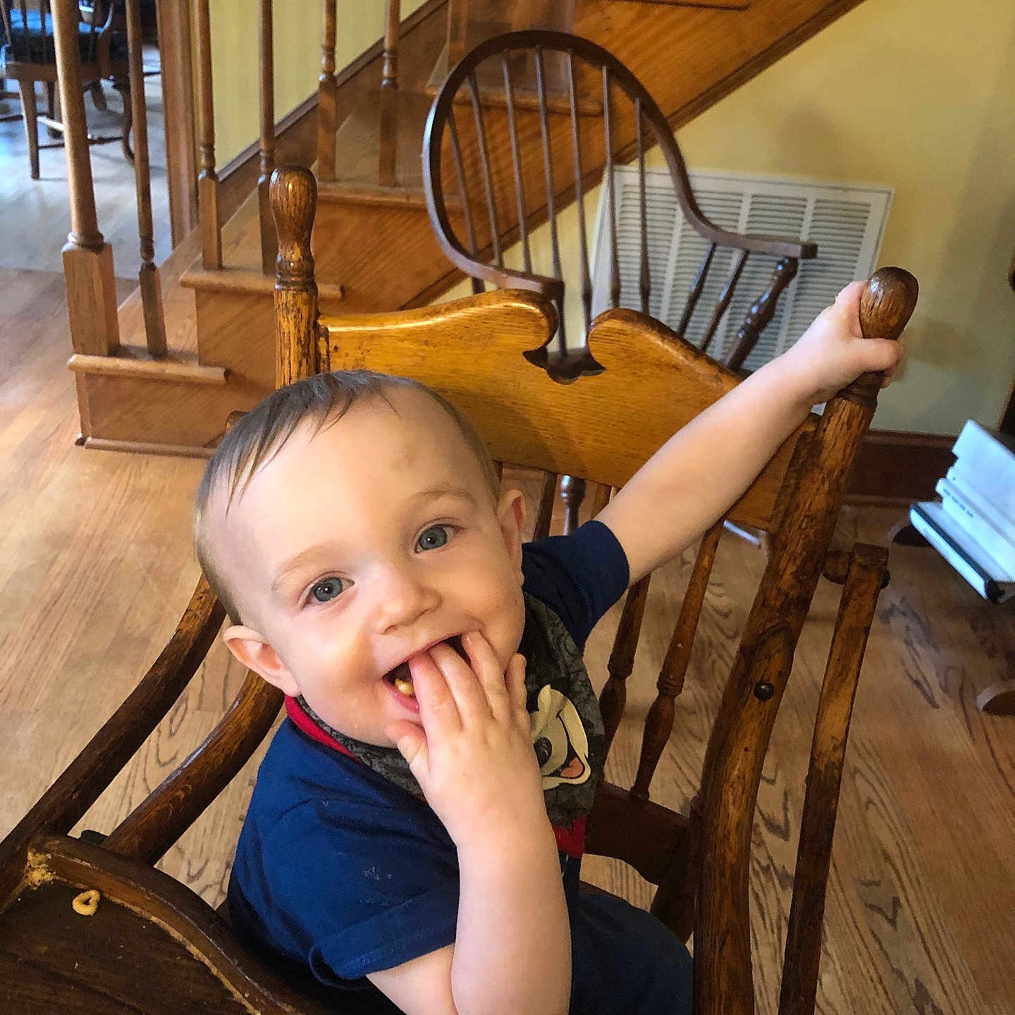 Bethany Gerstenmier is registered to the contest to win money with this photo: baby, blue_shirt, cereal, child, cute, face, food, hand, happy, high_chair, home, indoor, person, plate, smile, stairs, table, toddler, wood_floor, wooden_chair