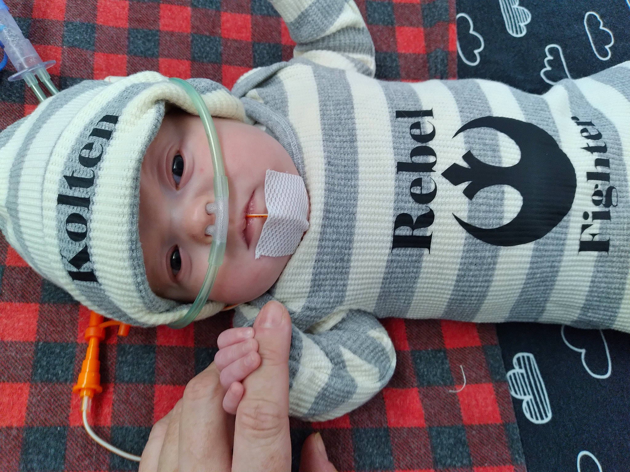 Kolten joined the competition — help win amazing prizes! baby, cap, child, comfort, cool, eye, finger, hand, happy, headgear, headwear, pattern, person, plaid, red, skin, sleeve, smile, tartan, textile