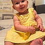Elowyn is registered to the contest to win money with this photo: baby, child, yellow_dress, sitting, bed, brush, cute, indoors, portrait, face, hands, feet, curious, soft_lighting, cozy, smiling, plush, infant, closeup, candid