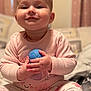 Elowyn joined the competition — help win amazing prizes! baby, child, smiling, pink_pajamas, ball, toy, hand, face, cute, indoor, sitting, childrens_toy, home, soft_lighting, playful, infant, person, portrait, close_up, happy
