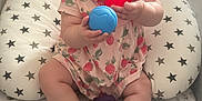 Elowyn is registered to the contest to win money with this photo: baby, child, playing, toys, rubber_ducks, colorful, cushion, playpen, star_pattern, pink_clothing, smiling, tongue_out, indoors, cute, infant, happy, sitting, person, floor, soft_toys