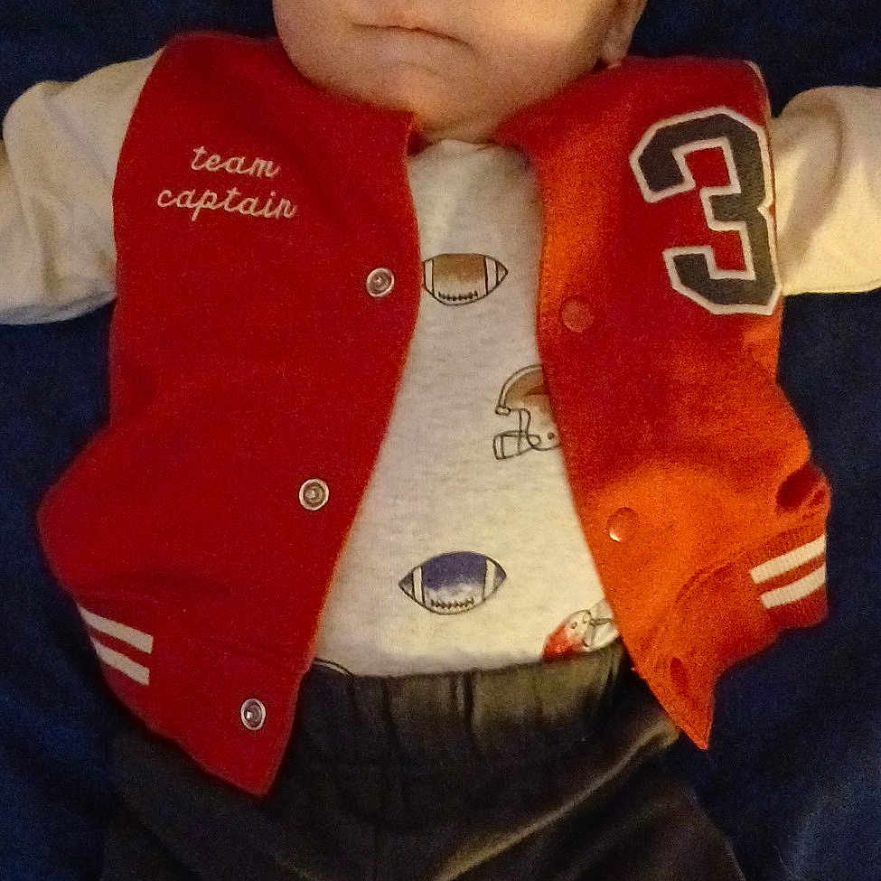 Liam joined the competition — help win amazing prizes! baby, clothing, coat, couch, cushion, face, furniture, head, homedecor, jacket, jeans, knitwear, lifejacket, pants, person, photography, portrait, shirt, sweater, vest