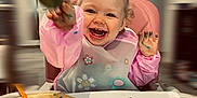 Cléa a rejoint le concours — aidez-le/la à gagner de superbes lots ! toddler, child, painting, art, paintbrush, palette, high_chair, smiling, happy, messy, colorful, indoor, apron, creative, playtime, hands, face, expression, paper, table