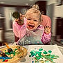 toddler, child, painting, art, paintbrush, palette, high_chair, smiling, happy, messy, colorful, indoor, apron, creative, playtime, hands, face, expression, paper, table