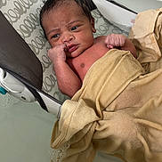 Kyan joined the competition — help win amazing prizes! awake, baby, bassinet, blanket, child, face, fist, hand, home, indoor, infant, lying_down, newborn, photography, portrait, serious_expression, sleeping_area, textile, towel, wrapped