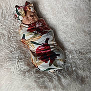 Evalynn is registered to the contest to win money with this photo: baby, newborn, sleeping, swaddle, floral_pattern, bow, blanket, soft_texture, cute, infant, headwear, peaceful, resting, portrait, indoor, cozy, wrapped, child, toddler, person