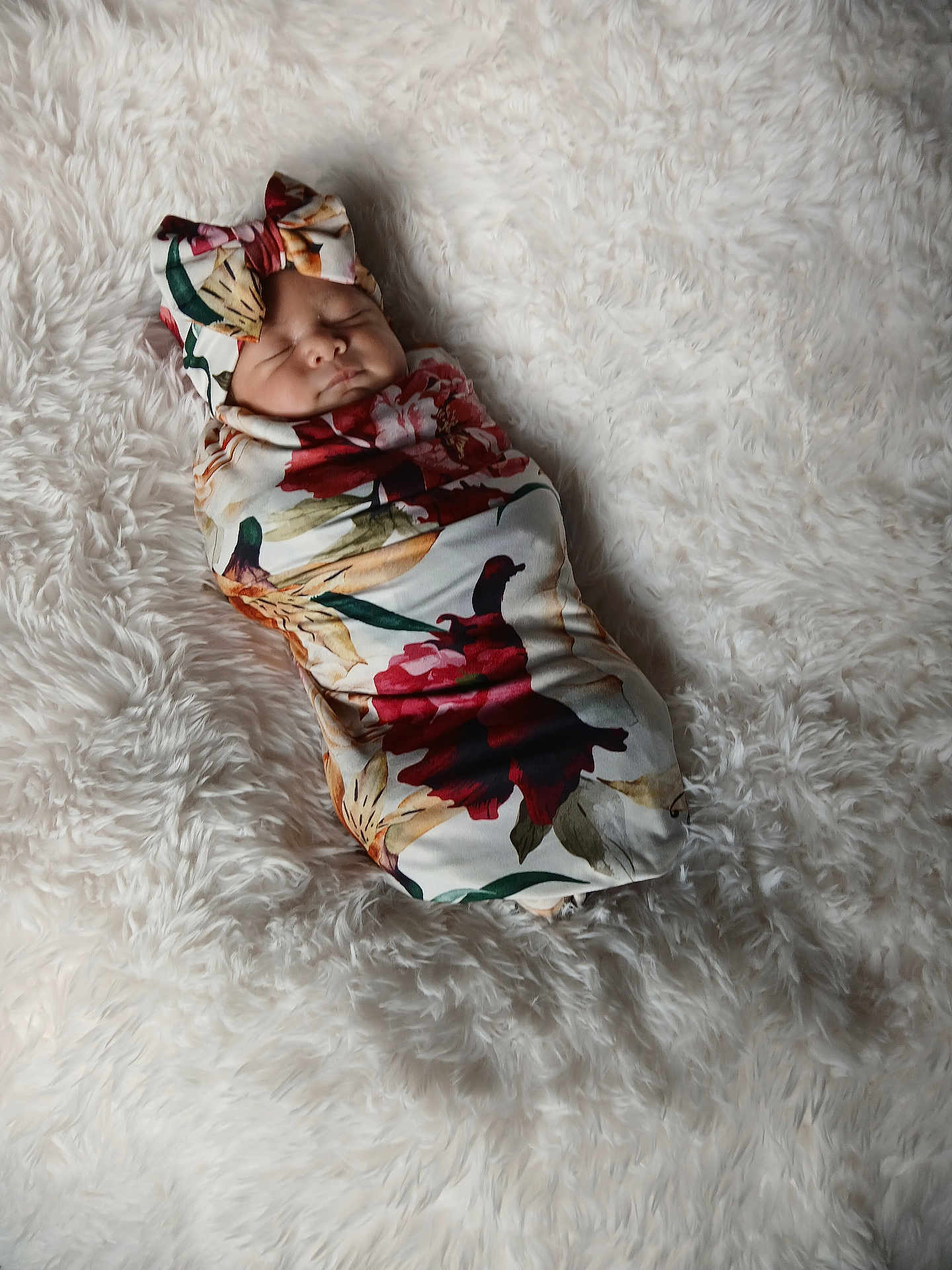 Evalynn is registered to the contest to win money with this photo: baby, newborn, sleeping, swaddle, floral_pattern, bow, blanket, soft_texture, cute, infant, headwear, peaceful, resting, portrait, indoor, cozy, wrapped, child, toddler, person