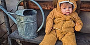 Gaspard a rejoint le concours — aidez-le/la à gagner de superbes lots ! baby, child, bench, watering_can, rustic, outdoor, brown_clothing, fuzzy_suit, cute, expression, wood, stone_floor, hat_with_ears, cold_weather, winter_clothes, seated, portrait, one_person, young_child, cozy