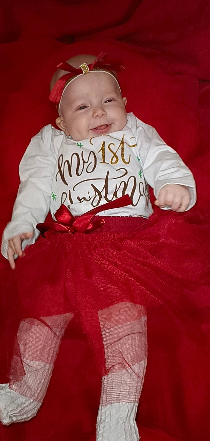 Luna a rejoint le concours — aidez-le/la à gagner de superbes lots ! baby, baby_toddler_clothing, cheek, child, chin, dress, event, eye, face, fun, happy, head, headwear, human_body, person, pink, sitting, skin, sleeve, smile