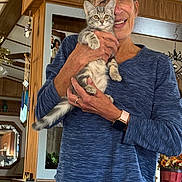 Teetee And Lil Baby joined the competition — help win amazing prizes! blue_sweater, casual_clothing, cat, curious, face, feline, hands, happy, holding, home_decor, indoor, kitten, living_room, pet, plant, portrait, smiling, watch, woman, wood_paneling