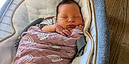 Scarlett joined the competition — help win amazing prizes! baby, bed, blanket, couch, cradle, crib, face, furniture, hardwood, head, infantbed, newborn, person, wood