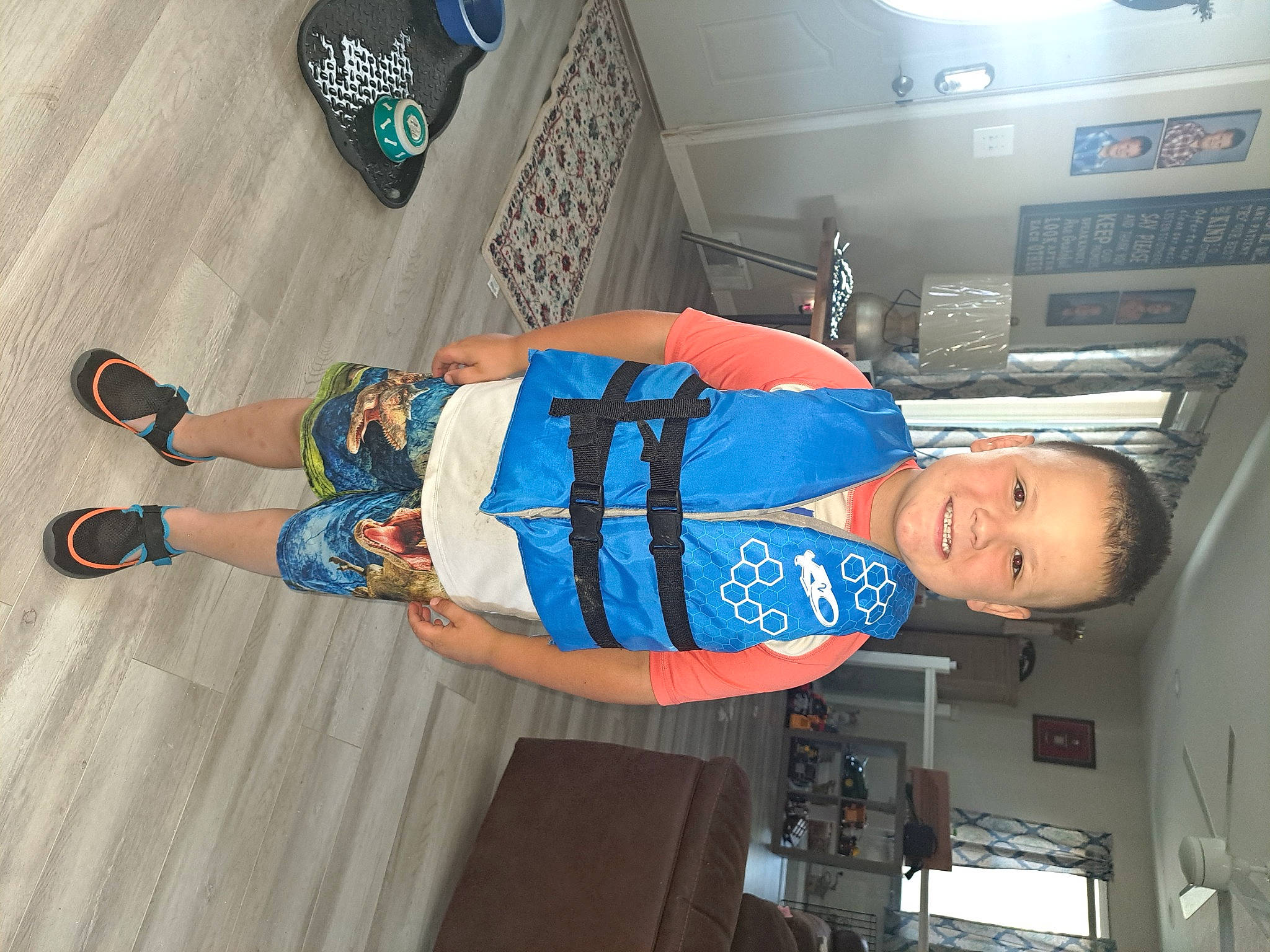 Jaxson is registered to the contest to win money with this photo: blurred, child, elbow, electric_blue, engineering, flooring, fun, hat, human_leg, joy, person, smile, t_shirt, thigh, walking_shoe, wrist