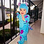 toddler, child, costume, blue, purple, monster, outdoor, balcony, railing, smiling, happy, standing, face, headwear, plush, daylight, person, cute, fun, playful