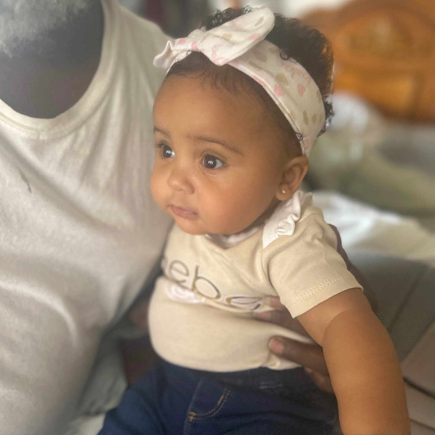 Aria joined the competition — help win amazing prizes! accessories, baby, baseballcap, clothing, couch, earring, face, furniture, happy, hat, head, jeans, jewelry, pants, person, photography, portrait, sitting, smile, t_shirt