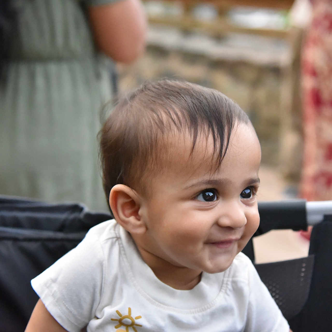 Hanvai is registered to the contest to win money with this photo: baby, child, smile, face, stroller, happy, cute, person, outdoor, infant, clothing, hair, portrait, young, joyful, expression, seat, toddler, head, skin