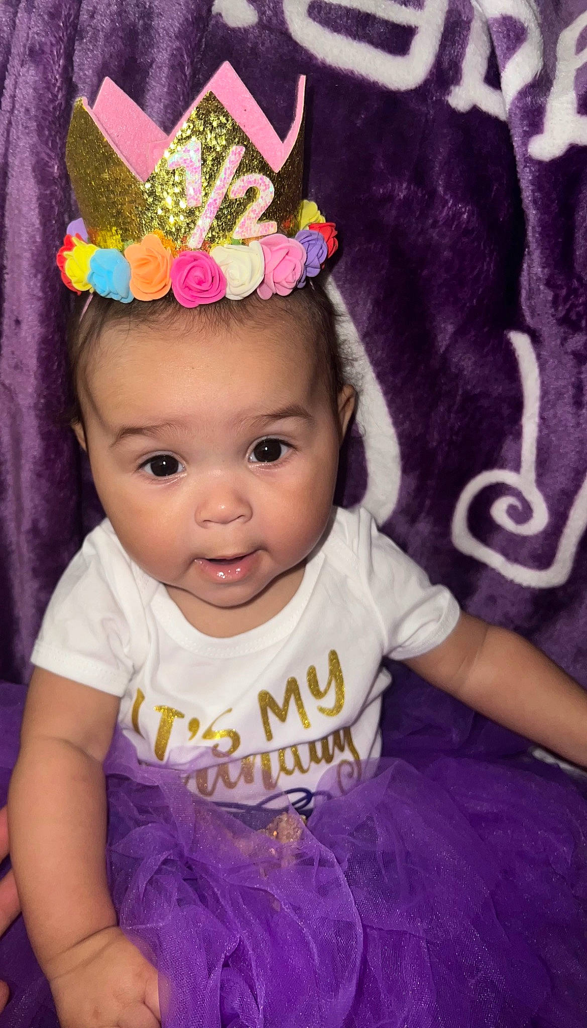 Brielle joined the competition — help win amazing prizes! baby, baby_toddler_clothing, cap, child, costume_hat, flower, hair_accessory, happy, headband, headgear, headpiece, iris, jewellery, magenta, necklace, person, pink, plant, purple, toddler