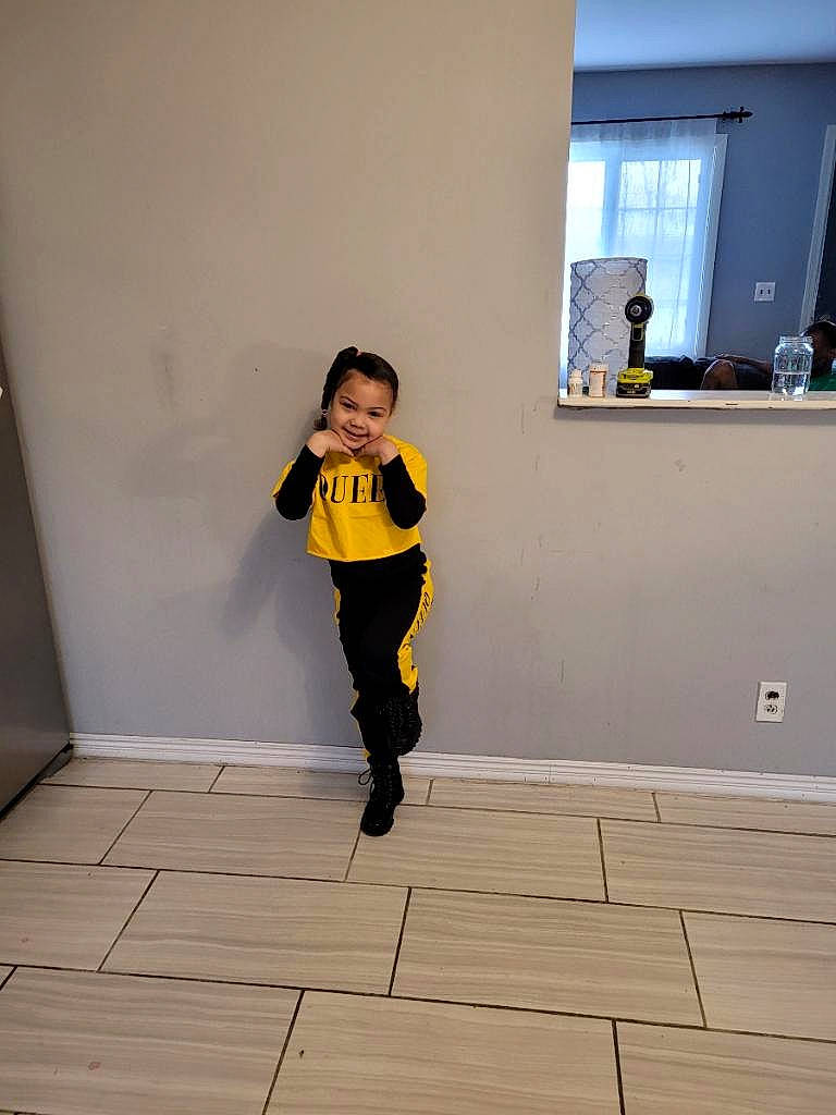 Alyona is registered to the contest to win money with this photo: child, door, fashion_design, floor, flooring, fun, hardwood, human_leg, joy, knee, laminate_flooring, person, room, sleeve, sweatpant, t_shirt, thigh, toddler, window, wood